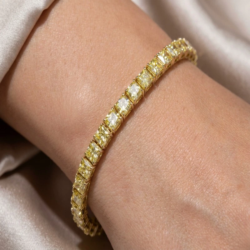 Cushion Cut Yellow Lab Diamond Tennis Bracelet in Yellow Gold Wearing Effect