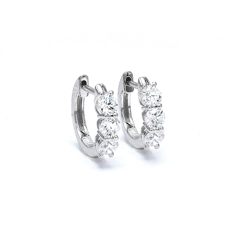 close up of three stone huggie earrings