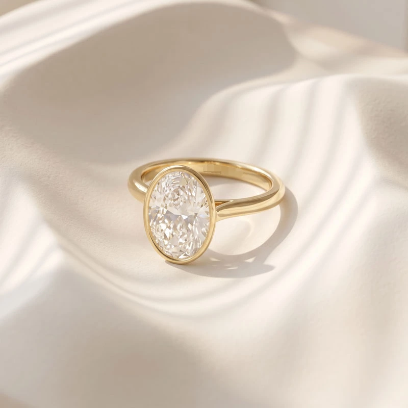 Oval Lab Diamond Bezel Solitaire Engagement Ring on cloth